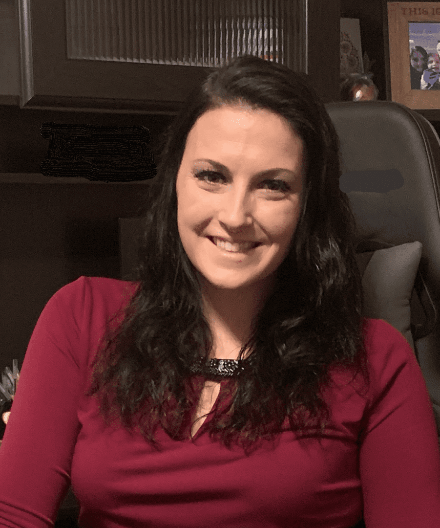 A woman sitting in a chair smiling for the camera.